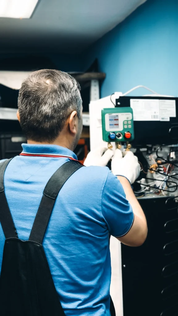 Technician servicing the indoor unit of a heat pump system
